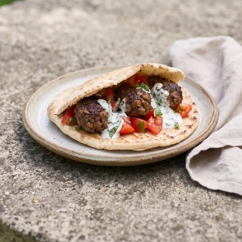 Beef Kofta Pitas with Tomato & Mint Yogurt - Spiced beef koftas cooked through and tucked into pitas with tomatoes and cool mint yogurt