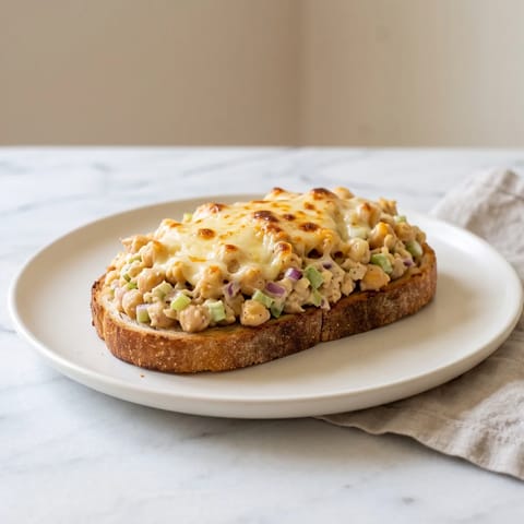 Chickpea "Tuna" Melts - Mashed chickpeas dressed like a deli tuna salad, piled on toast under bubbling cheddar