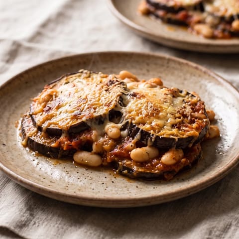 Eggplant Parmigiana with White Beans - Roasted eggplant layered with tomato sauce, mozzarella and Parmesan, with white beans folded in for substance