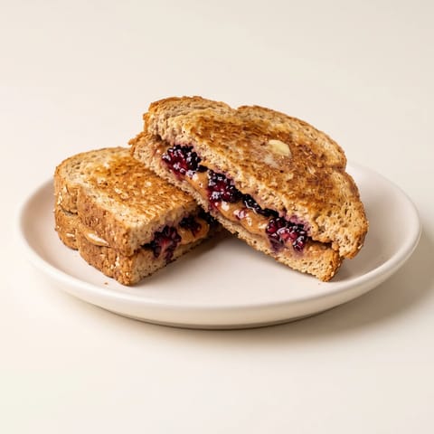 Grilled Blackberry & Almond Butter Sandwich - A golden grilled sandwich of almond butter and smashed blackberries