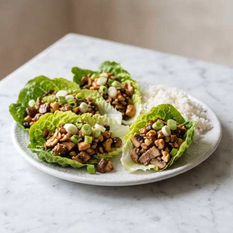 Hoisin Mushroom & Cashew Lettuce Wraps - Meaty chopped mushrooms and cashews in a sticky hoisin glaze, spooned into cool lettuce cups