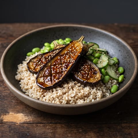 Miso Eggplant & Brown Rice Bowls - Roasted eggplant lacquered in miso-maple glaze over brown rice with edamame and quick-pickled cucumber