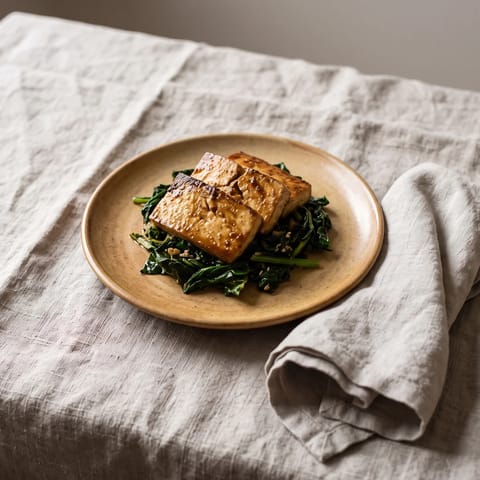 Miso-Glazed Tofu with Sesame Greens - Caramelized miso tofu over garlicky greens