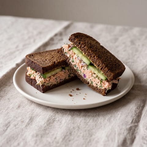 Salmon Salad Sandwich on Rye - Canned salmon mashed with yogurt and dill on dark rye