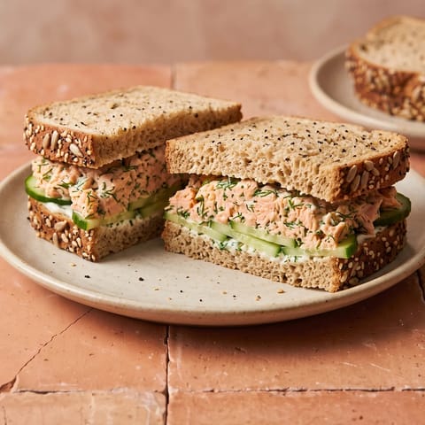 Salmon Salad Sandwich on Seeded Bread - Canned salmon mashed with yogurt, lemon and dill, piled on seeded bread with cucumber