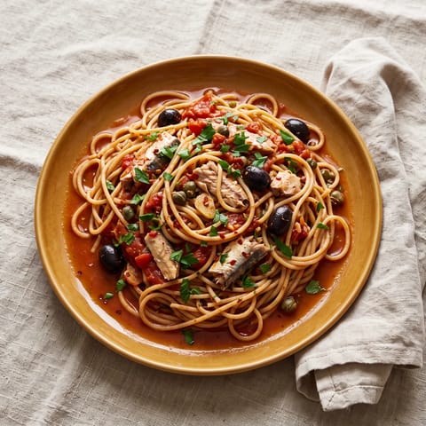 Sardine Puttanesca with Whole-wheat Spaghetti - A punchy pantry puttanesca where sardines melt into tomatoes, olives and capers