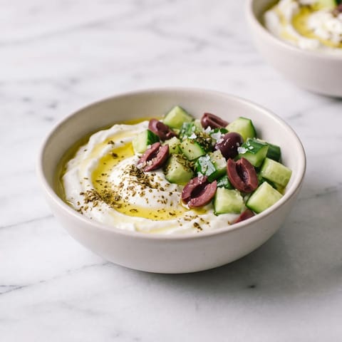 Savory Yogurt Bowl with Cucumber, Olive & Za'atar - Thick yogurt swirled with olive oil under cucumber, olives and za'atar