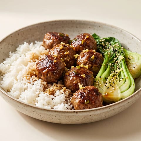 Sticky Tamari Meatballs with Sesame Greens & Rice - Beef and pork meatballs lacquered in a sticky tamari-ginger glaze with sesame bok choy and rice