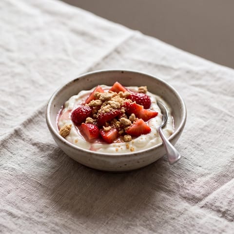 Strawberry Cheesecake Yogurt Bowls - Thick yogurt whipped with cream cheese and vanilla under macerated strawberries and cookie crumbs