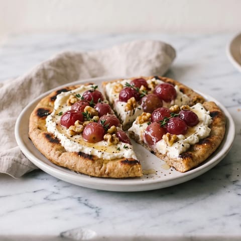 Whipped Feta & Roasted Grape Flatbreads - Warm flatbreads spread with whipped feta under sticky roasted grapes, walnuts and thyme
