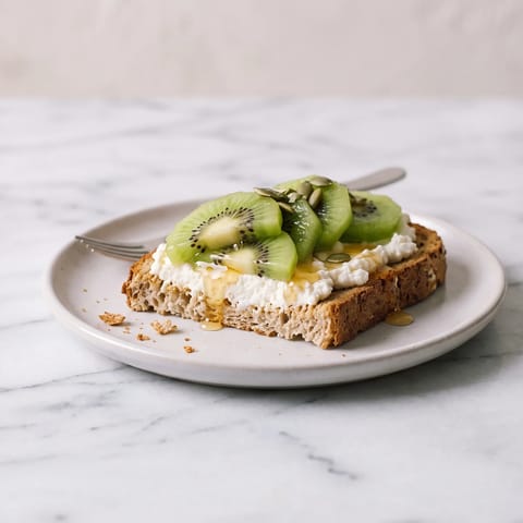 Whole-Grain Toast with Ricotta, Kiwi & Honey - Creamy ricotta toast topped with kiwi and a thread of honey