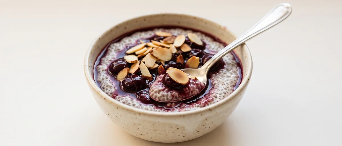 Cherry & Almond Chia Pudding - Vanilla chia pudding under a spoon of warm cherry compote and toasted almonds