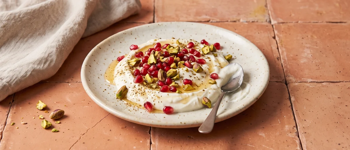 Greek Yogurt with Pomegranate & Pistachios - Thick Greek yogurt under a shower of pomegranate seeds, pistachios and honey