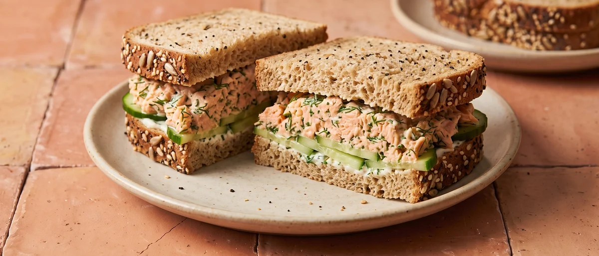 Salmon Salad Sandwich on Seeded Bread - Canned salmon mashed with yogurt, lemon and dill, piled on seeded bread with cucumber
