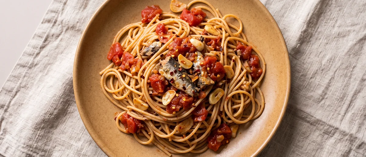 Sardine Puttanesca with Whole-wheat Spaghetti - A punchy pantry puttanesca where sardines melt into tomatoes, olives and capers