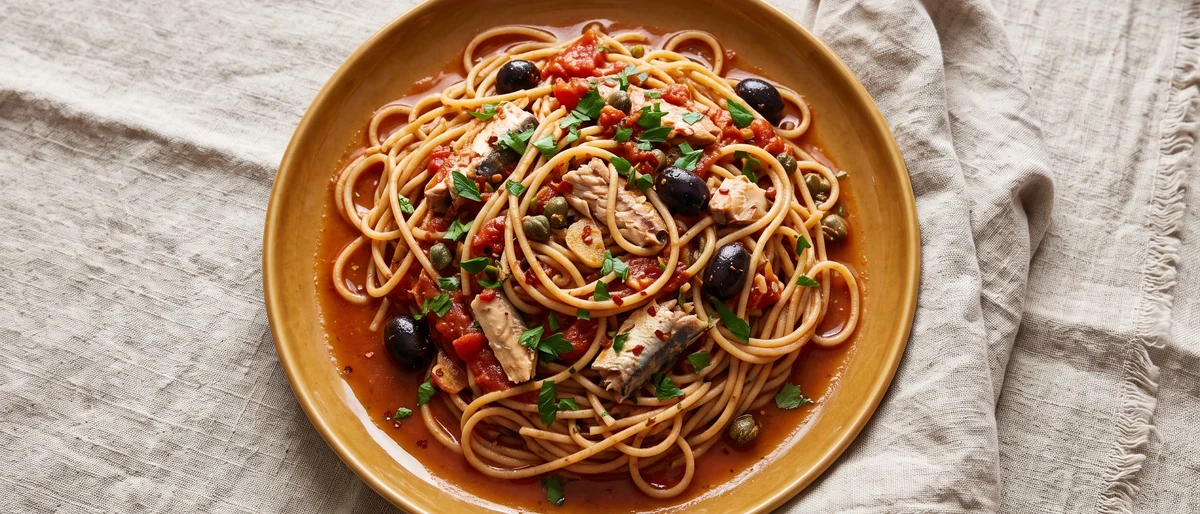 Sardine Puttanesca with Whole-wheat Spaghetti - A punchy pantry puttanesca where sardines melt into tomatoes, olives and capers