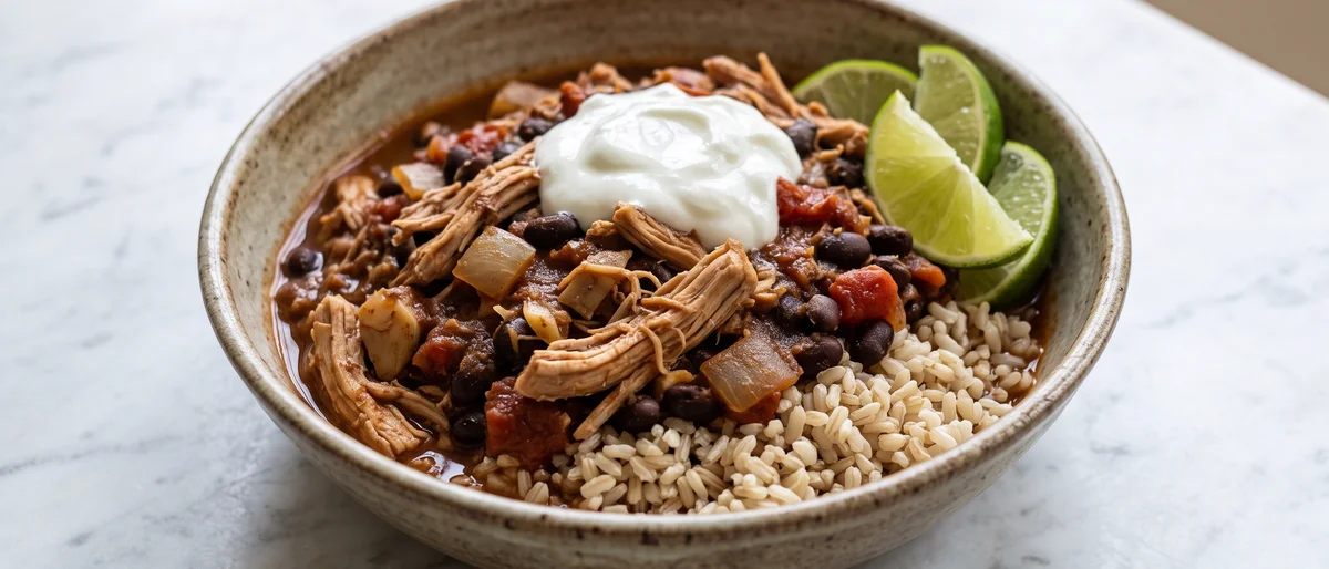Slow-Cooker-Style Pulled Chicken Chili Bowls - Pulled chicken simmered in a smoky tomato-bean chili