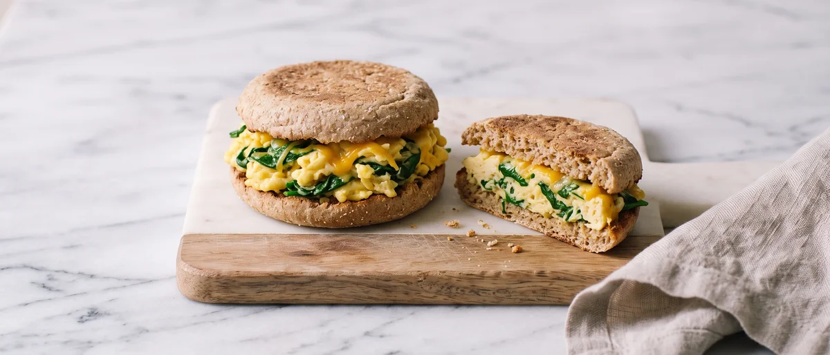 Spinach & Cheddar Scrambled Egg Muffin - Fully-set scrambled eggs with wilted spinach and sharp cheddar in a toasted English muffin