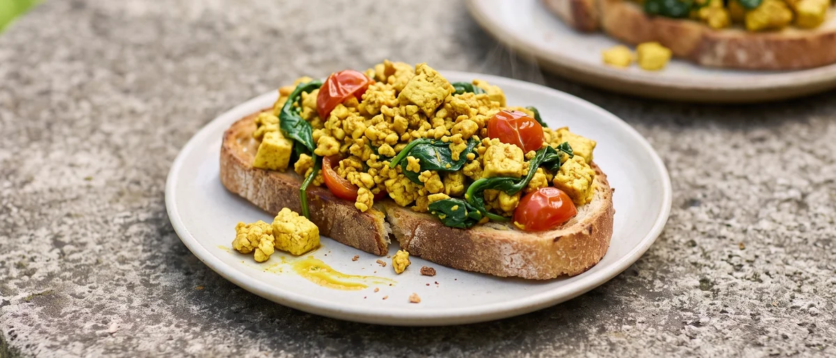 Tofu & Spinach Breakfast Scramble on Toast - Turmeric-golden tofu scramble with spinach and cherry tomatoes on toast