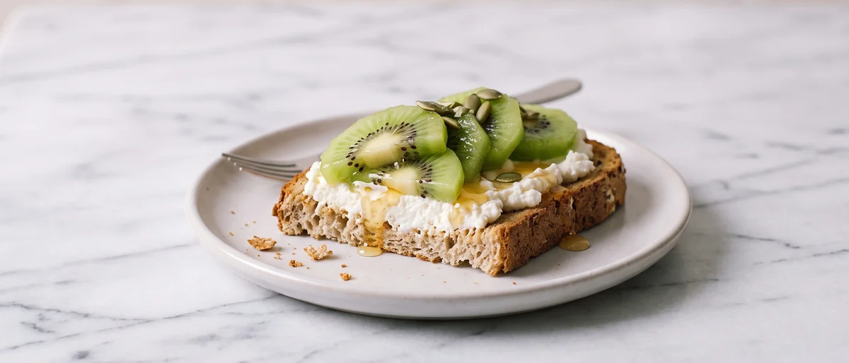 Whole-Grain Toast with Ricotta, Kiwi & Honey - Creamy ricotta toast topped with kiwi and a thread of honey